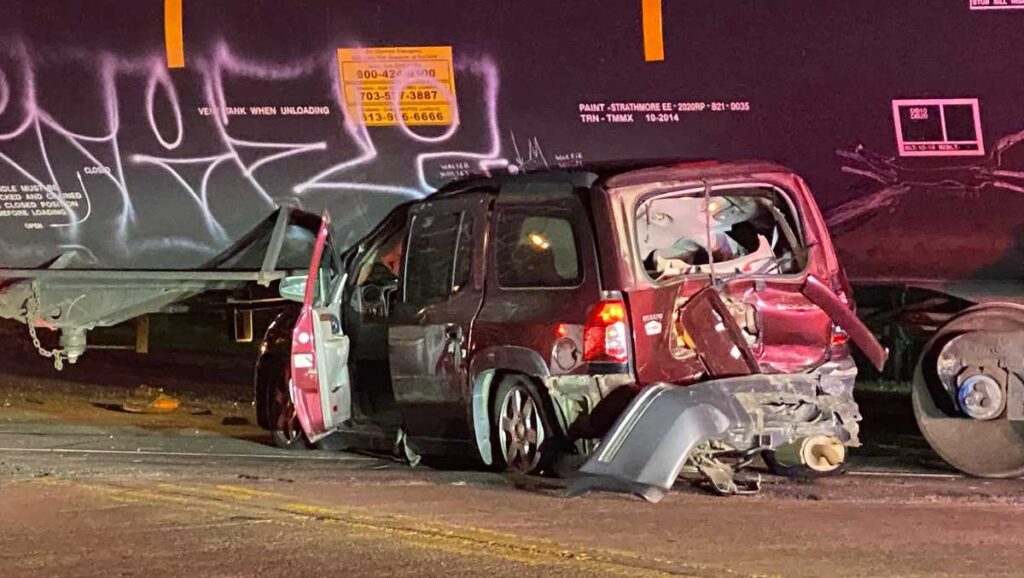 Del Metropolis collision causes car to be wedged below prepare